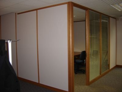 Corner Office Addition With Glazed and Solid Partitions