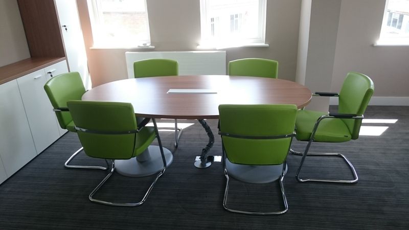 Elliptical Walnut Boardroom Table with Green Meeting Chairs