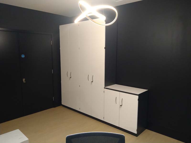 Special storagewall cupboards with white doors and slate carcass for reception office.