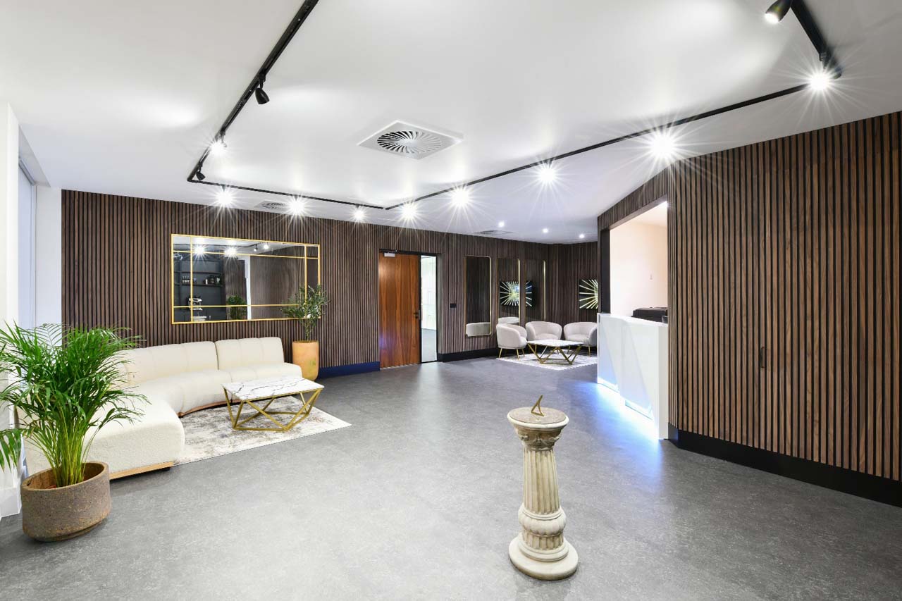 View of stylish office reception area with stunning white glass reception desk